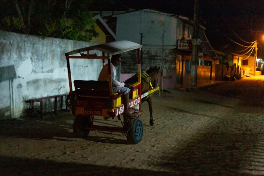 A villager with his horse wagon, entitled Abencoado (Blessed), arrive at the Algodoal village, now with street lighting.